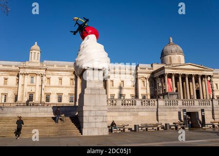 The End. Dollop of whipped cream with assortment of toppings: a cherry, a fly, and a drone. Fourth plinth art outside National Gallery. Lockdown quiet Stock Photo