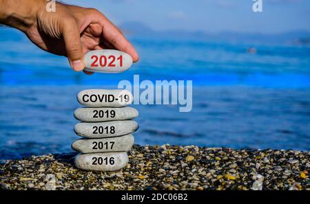 New Year 2021 is coming concept. Covid year change to 2021 background. Turn of old year concept. Happy new year 2021 replace Corona. Stock Photo