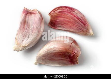 Top view on three purple garlic cloves isolated (with shadows) on white background. Stock Photo