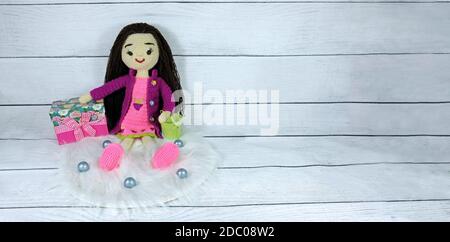 Amigurumi doll and pink gift box Stock Photo