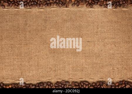 Coffee beans lying on sackcloth with space for text Stock Photo