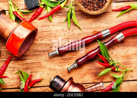 Oriental hookah with tobacco aroma of red hot pepper. Hookah with chilli  pepper flavor Stock Photo