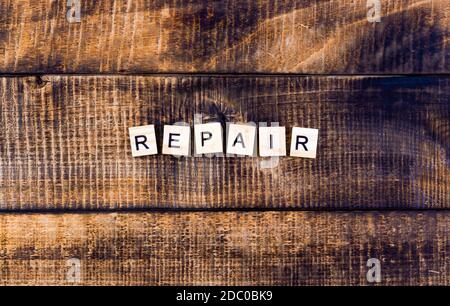 Repair word on wooden background. Collage of tools. Stock Photo