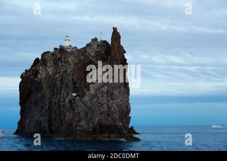 Sicily, Italy. The Strombolicchio Lighthouse sits on top of a volcanic sea stack about a mile from the volcanic island of Stromboli. Stock Photo