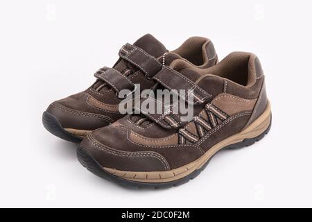 Men's suede brown low shoes with laces on a black background Stock