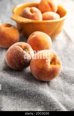 Fresh ripe bio peaches on tablecloth. Stock Photo