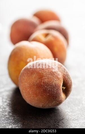 Fresh ripe bio peaches on black table. Stock Photo