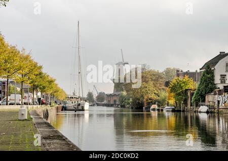 Schiedam, the Netherlands, October 23, 2020: a mix of modern and traditional industries around Buitenhaven (outer harbour) with a sailboat and the Nol Stock Photo