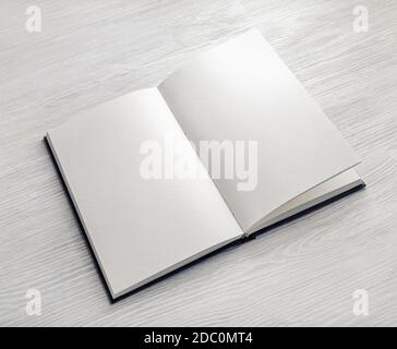 Mockup of opened blank booklet on light wooden background. Stock Photo