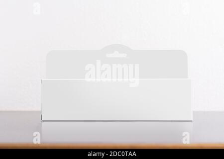 Rectangular box package mockup with hanger on table, editable mock-up series template ready for your design, faces selection path included. Stock Photo