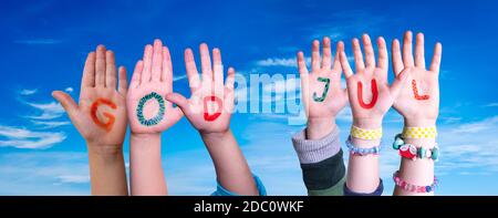 Children Hands Building Colorful Swedish Word God Jul Means Merry Christmas. Blue Sky As Background Stock Photo