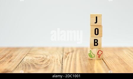 cubes with the word JOB and thumbs-up and thumbs-down icons on wooden table on white background - 3d illustration Stock Photo