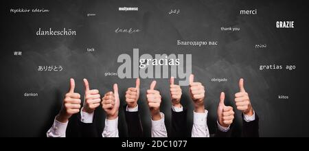 many thumbs up and blackboard with message THANK YOU in different languages Stock Photo