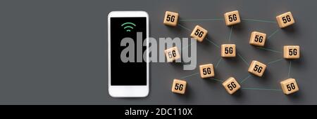 cubes with 5G symbol and a smartphone on grey background Stock Photo