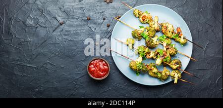 Vegetable kebab from broccoli cabbage.Fried cabbage on wooden skewers Stock Photo
