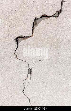 Crack on a grey concrete wall of abandoned house in Al Madam ghost village in United Arab Emirates, industrial background. Stock Photo