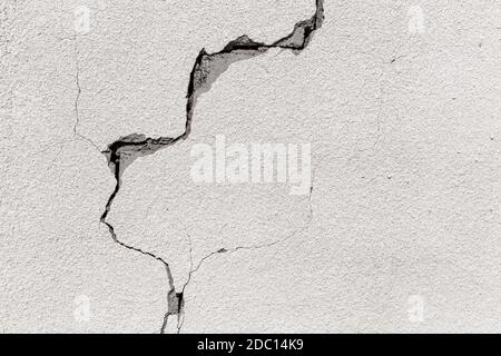 Crack on a grey concrete wall of abandoned house in Al Madam ghost village in United Arab Emirates, industrial background. Stock Photo