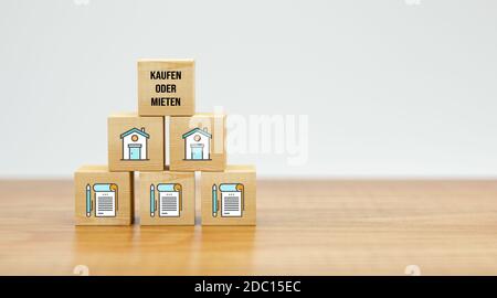 cubes with house symbols and message BUYING OR RENTING on white background - 3d illustration Stock Photo