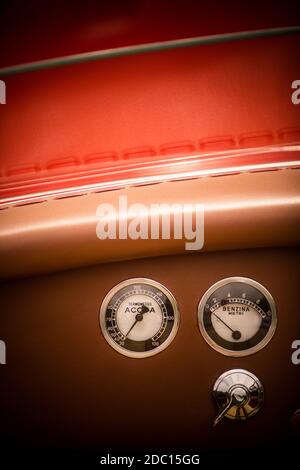 Color close up shot of a coolant temperature and fuel level gauges on a vintage car's dashboard. Stock Photo