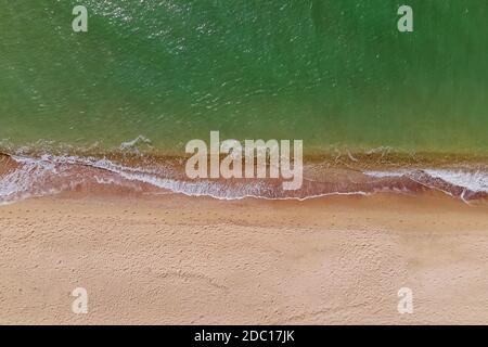 Aerial top view of the beach with sand and small waves Stock Photo