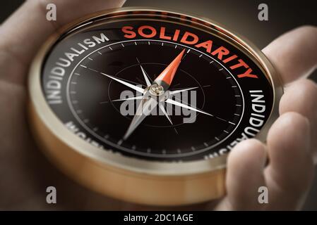 Man hand holding compass with needle pointing the word solidarity. Sociology concept. Composite image between a hand photography and a 3D background. Stock Photo