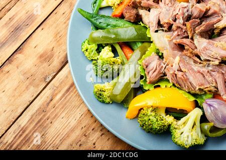 Appetizing beef stew with seasonal vegetables.Sliced pieces of baked beef laid and vegetables Stock Photo