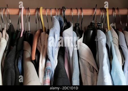Mens clothes on a clothes rail in a wardrobe. 17.11.2020. Photograph: Stuart Boulton. Stock Photo