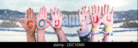 Children Hands Building Colorful Swedish Word God Jul Means Merry Christmas. Snowy Winter Background With Snowflakes Stock Photo