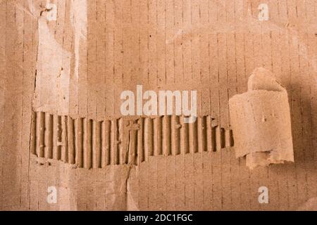 Top view of torn edges corrugated brown cardboard sheet of paper texture or background flat lay, Folded recycle carton paper box Stock Photo