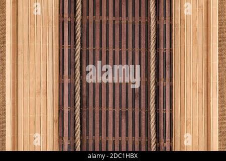 Bamboo mat twisted in the form of a manuscript and rope on sackcloth, with space for your text Stock Photo