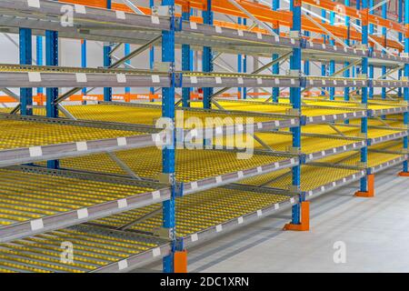 Gravity Flow Rack Shelving in Distribution Warehouse Stock Photo