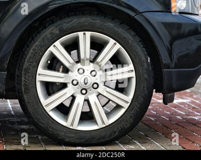 Grodno, Belarus, December 2012: Land Rover Range Rover Sport V8 Supercharged side view car wheel with winter Couragia SU tire disc brake alloy disc Stock Photo