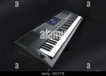 Studio shot of a Yamaha electronic keyboard; Model PSR EW400 on a folding, metal  X-frame stand. Stock Photo