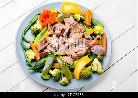 Appetizing beef stew with seasonal vegetables.Sliced pieces of baked beef laid and vegetables Stock Photo