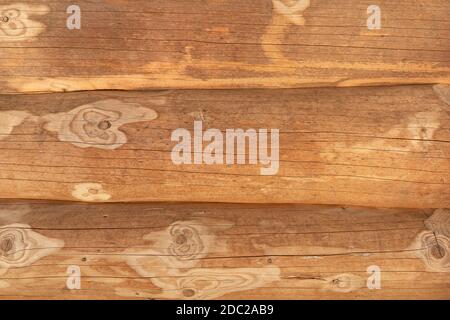 Closeup of three tree trunks of a log house lying on top of each other Stock Photo