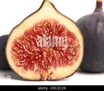 ripe whole and halved purple figs isolated on white background, close up Stock Photo