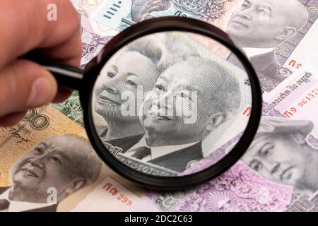 Cambodian riel in a magnifying glass Stock Photo