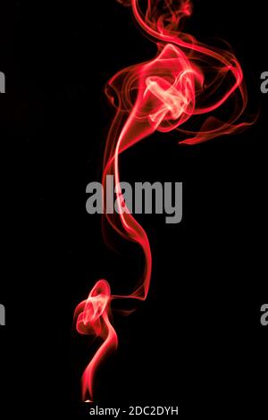 multicolored smoke of pink and red colors on a black isolated background. blur stock image Stock Photo