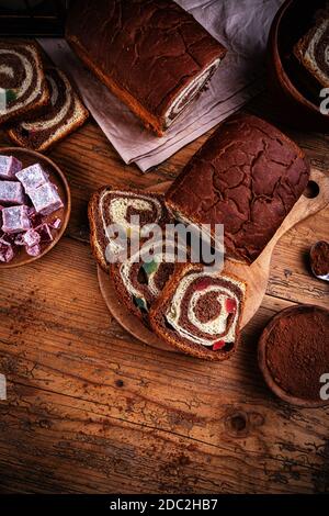 Swirl brioche with cocoa and Turkish delight on wooden background Stock Photo