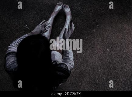 Horror woman ghost creepy sitting at the house, halloween day concept Stock Photo