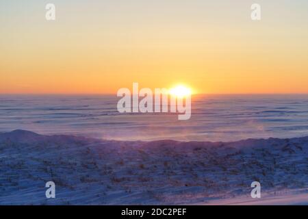 Mist rising along a frozen shore at sunset on Prince Edward Island, Canada. Stock Photo