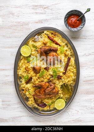 Homemade chicken Biryani. Arabic traditional food bowls Kabsa with meat. Top view. Stock Photo