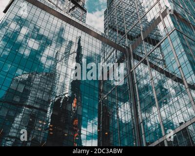 Abstract background with blurred reflections in mirrors. Modern business center made of glass and concrete with abstract reflections. Stock Photo