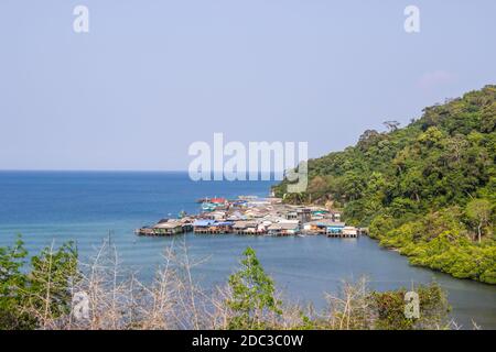 Soft focus. Fishermen's village at extended into the sea of Koh Kood with floating houses and restaurant on the island, Trat Province, Thailand. Stock Photo