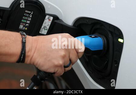 An electric charging cable connected to a Jaguar I-Pace electric car. Stock Photo