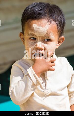Daily life in Myanmar - young local boy with thanaka on face at Bagan, Myanmar (Burma), Asia in February Stock Photo