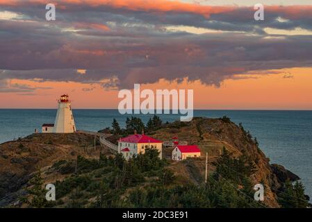 swallowtail lighthouse with beautiful sunset colors overlooking the bay of fundy Stock Photo