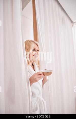 Joyful female with a herbal tea in a beauty salon Stock Photo