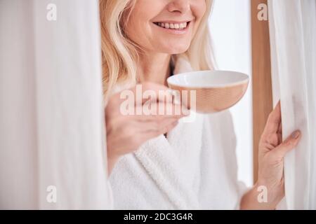 Female client with a herbal drink in the wellness center Stock Photo