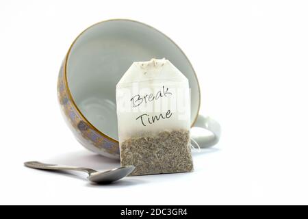 Cup and tea bag labeled Break Time against a white background Stock Photo
